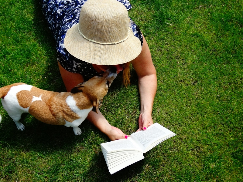 Woman reading outside with dog